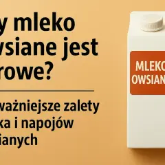 Biały kartonik mleka owsianego na pomarańczowym tle z tekstem.