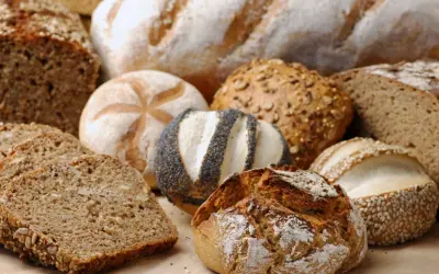 Różnorodne pieczywo pełnoziarniste i bułki z ziarnami, makiem i sezamem.